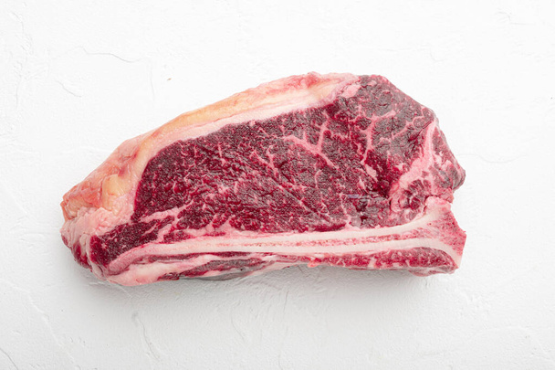 Fresh, huge and appetizing dry aged club steak set, on white stone  background - Photo, image