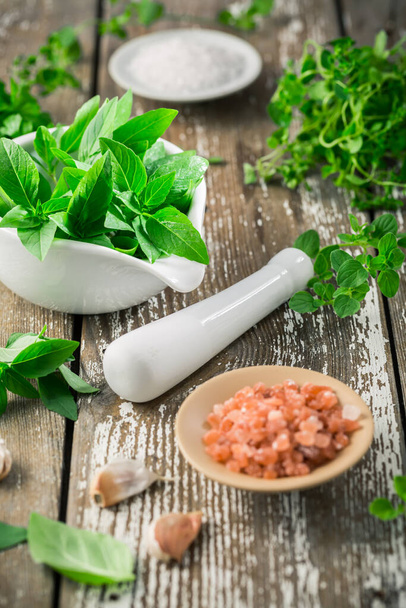 Thai basil, rosemary and other herbs with Himalayan salt for healthy cooking - Fotografie, Obrázek