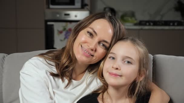 Mother and daughter smile widely looking in camera at home - Footage, Video