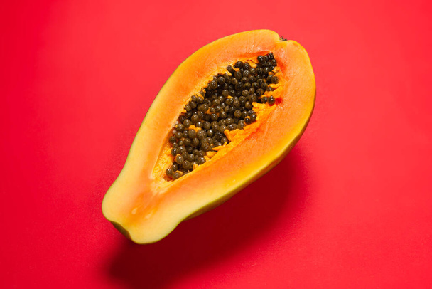 Turuncu arka planda Papaya meyvesi. Tropik meyve. Yarım papaya..  - Fotoğraf, Görsel