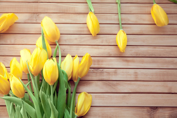 bouquet of yellow tulips on wooden background - Photo, image