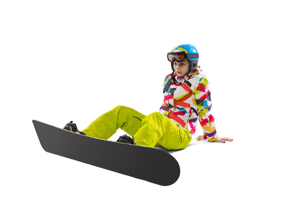 Portrait of young woman in bright sportswear, goggles and helmet snowboarding isolated on white studio background. Concept of winter sports - Photo, Image