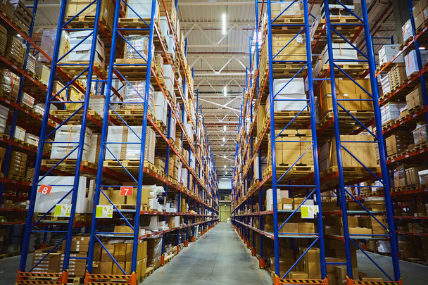 Interior of a modern warehouse storage of retail shop with pallet truck near shelves - Foto, Bild