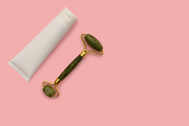 Cosmetic roller for the face, white container on a pink background. - Valokuva, kuva