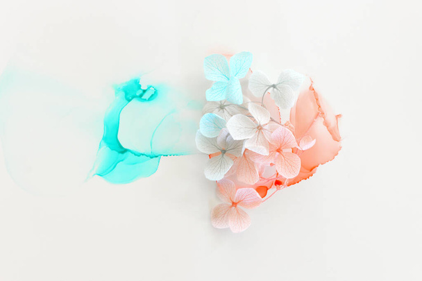 Kreatives Bild von pastellblauen und rosa Hortensienblüten auf künstlerischem Tuschehintergrund. Draufsicht mit Kopierraum - Foto, Bild