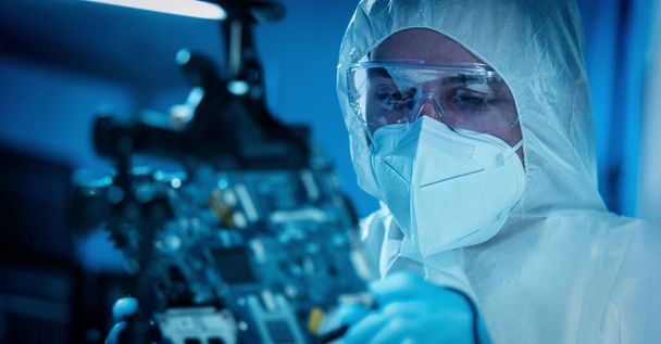 The scientist works in a modern scientific laboratory for the research and development of microelectronics and processors. Microprocessor manufacturing worker uses computer technology and equipment. - Photo, Image
