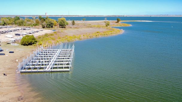 Aerial view galvanized steel dock systems under construction at Grapevine Lake, Texas, USA. Covered boat and yacht dock systems with super span roof installation on freshwater environment - Photo, Image