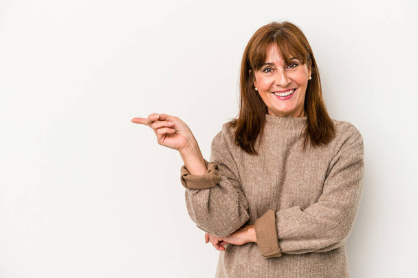 Middle age caucasian woman isolated on white background smiling cheerfully pointing with forefinger away. - 写真・画像