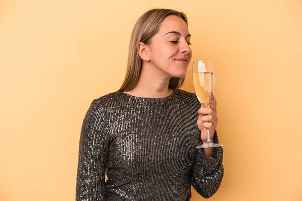 Young caucasian woman celebrating new year isolated on yellow background - 写真・画像