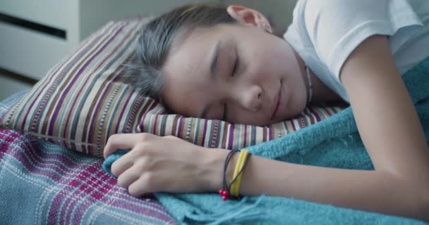 Morning - 10-year-old girl sleeping under a blanket. - Materiał filmowy, wideo