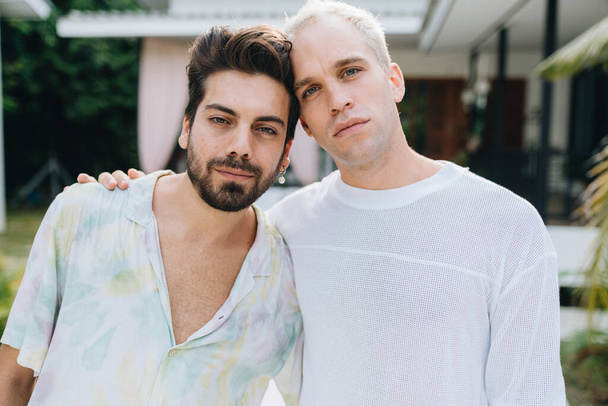 Gay hugging couple standing in front of their house outdoors - Foto, immagini