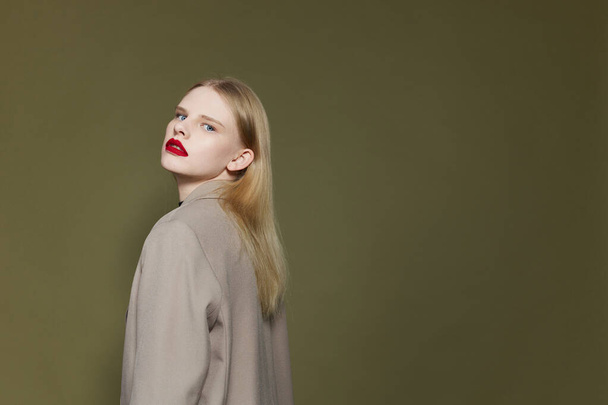 glamorous woman with red lips coat bright makeup studio model unaltered - Zdjęcie, obraz