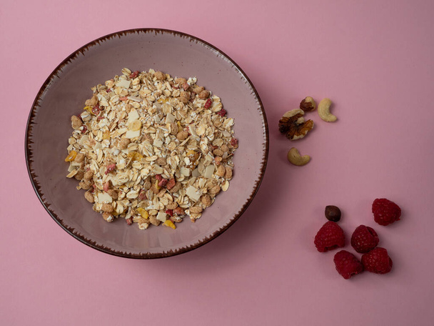 Muesli in a pink cup on a pink table. Muesli on a pink background. - Foto, Imagem