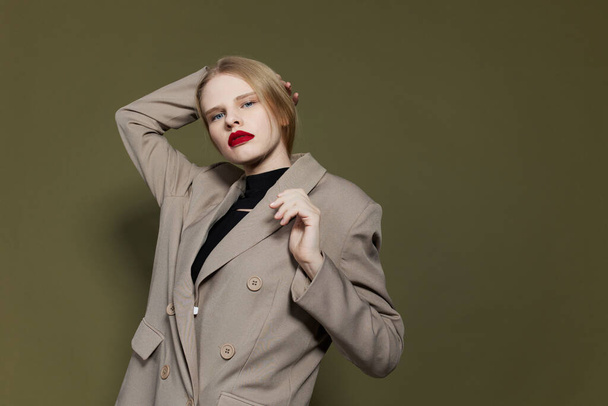 portrait of a woman with red lips coat bright makeup isolated background - 写真・画像