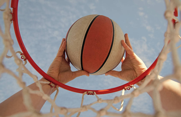 scoring during basketball game. ball goes through basket. man throwing the ball in hoop - Fotoğraf, Görsel