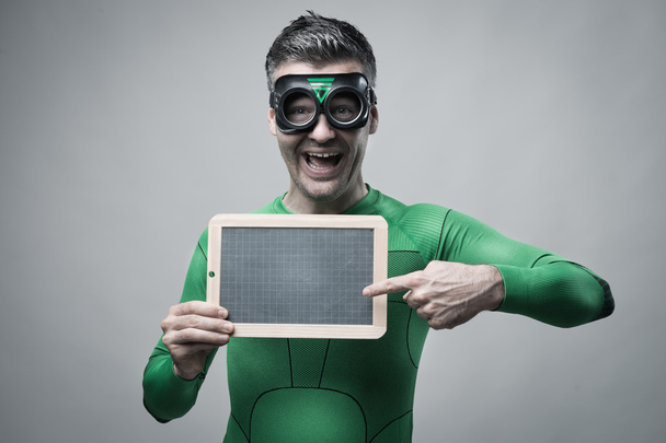 Cheerful superhero holding a blackboard - Foto, Imagem