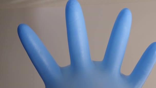 Closeup shot of a blue latex glove full of air. - Filmati, video