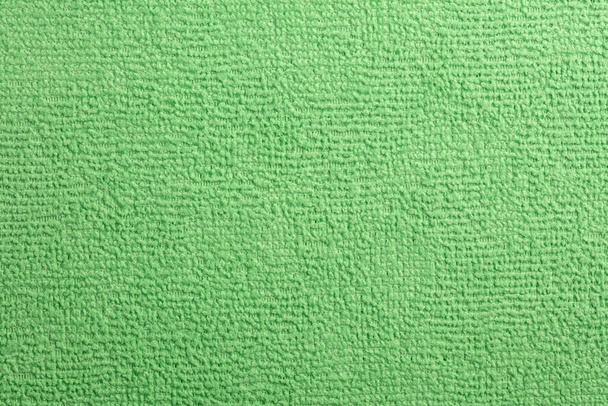 Asciugamano in microfibra verde Terry Texture orologio da polso. Panno in microfibra con primo piano. Struttura in tessuto sfondo. Tessuto blu modello. Servizio di pulizia. Oggetto macro.  - Foto, immagini