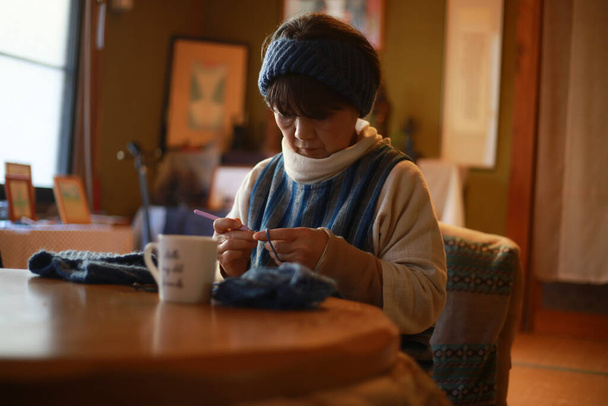Female hand-knitting neck warmer  - Photo, image