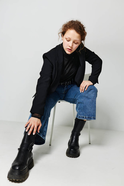 beautiful woman sitting on a chair in a black jacket fashion posing Lifestyle unaltered - Фото, изображение