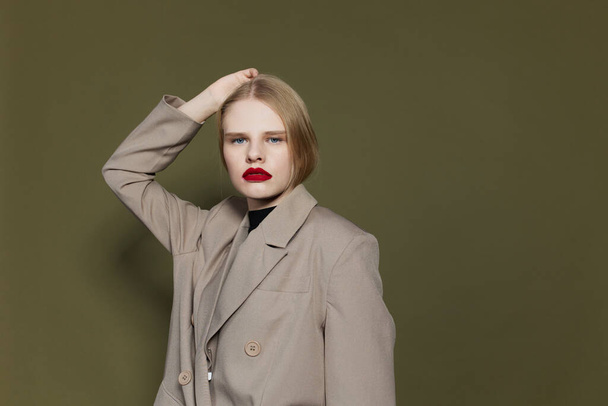 fashionable woman in coat red lips fashion studio model unaltered - Photo, Image