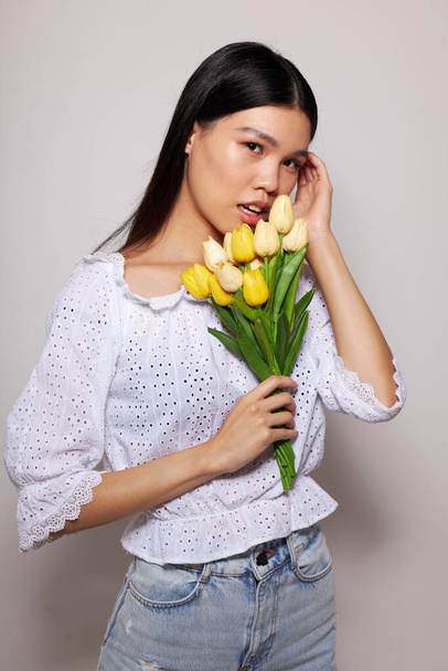Charming young Asian woman with a bouquet of flowers smile close-up isolated background unaltered - Fotografie, Obrázek
