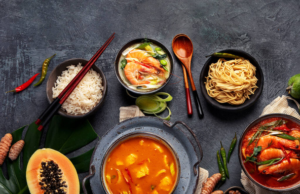 Traditional Thai food on dark background. Oriental food concept. Top view, flat lay, copy space - Fotó, kép