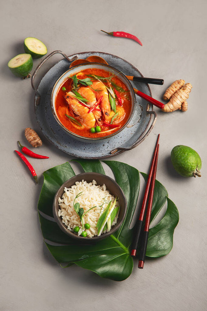 Red curry with chicken in bowl on light gray background. Traditional Asian food. Top view, flat lay - Zdjęcie, obraz