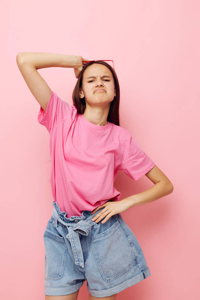 young beautiful woman in a pink t-shirt casual clothes pink background - Φωτογραφία, εικόνα