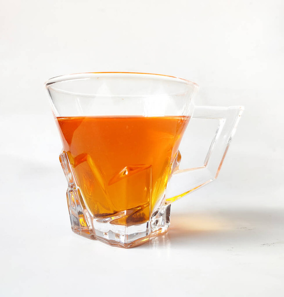 A cup of red tea on a white background.Rooibos tea.red bush tea. - Fotó, kép