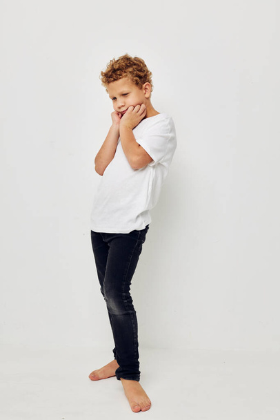 boy in a white t-shirt barefoot in full growth - Φωτογραφία, εικόνα