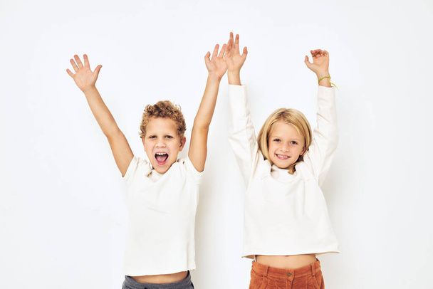 Two preschool children boy and girl gesticulate with their hands isolated background - Fotoğraf, Görsel