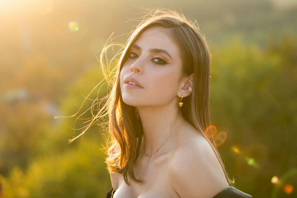 Beautiful girl face closeup, outside portrait of young woman. Summer romantic casual woman. Young woman outdoor enjoying the sunlight. - 写真・画像