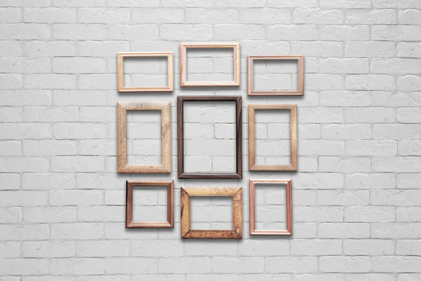 old photo frames on white brick wall - Photo, Image