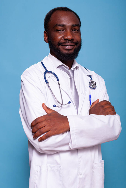 Vertical portrait of african american medical doctor with stethoscope posing confident - Foto, Bild