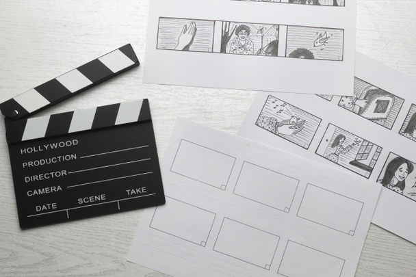 Characters storyboard drawings and movie clapperboard on the artist's desktop. - 写真・画像