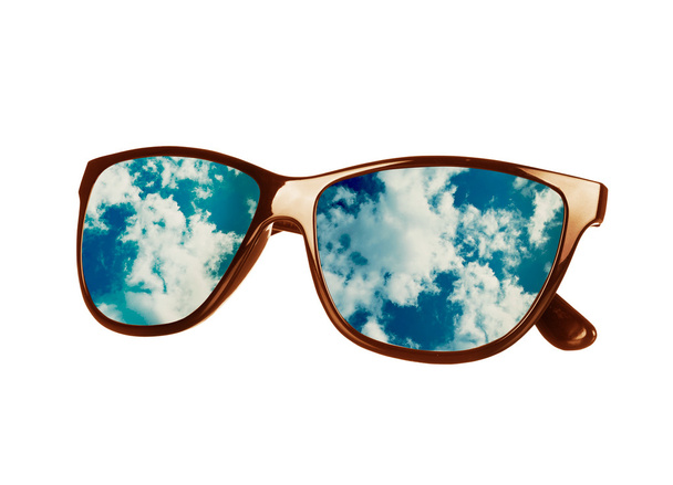 sun glasses have a sky reflecting on an isolated - Photo, Image