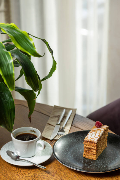 dessert decorated with raspberries, served with coffee. Photo of dessert in the interior - Valokuva, kuva