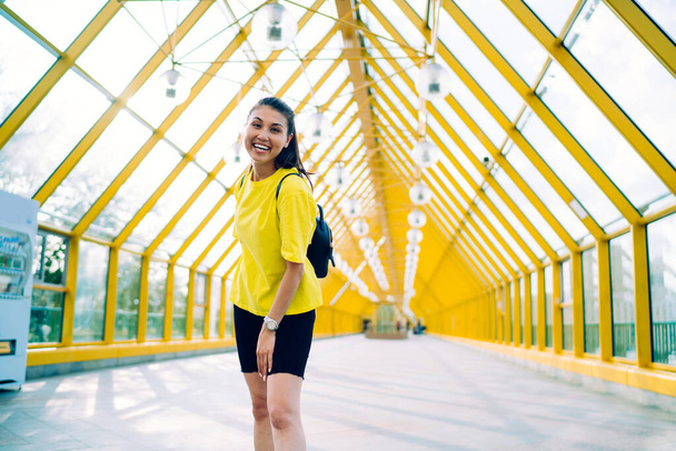 Portrait of cheerful asian female in activewear having training on street looking at camera feeling carefree, happy hipster girl looking at camera enjoying rest and healthy lifestyle outdoors - Photo, Image