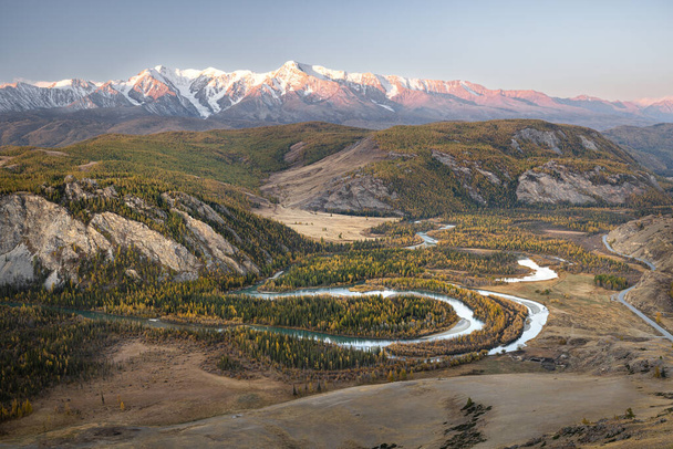 Mountain landscape against the background of a winding river, highway and blue sky in autumn at dawn. Altai, Russia. - 写真・画像