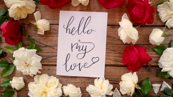 HELLO MY LOVE card on a wooden table top view zoom in - Filmmaterial, Video