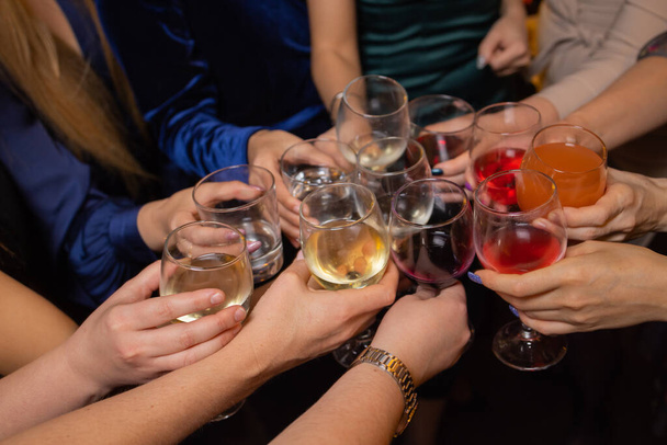 Celebrating with glasses of alcohol in hands. Happy female friends having good time. - Zdjęcie, obraz