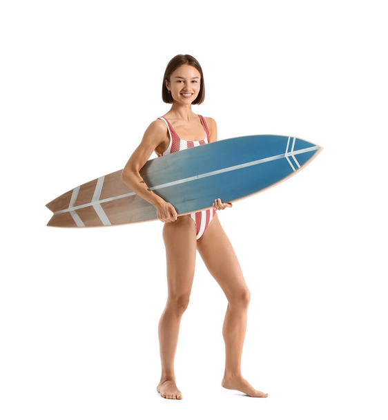 Beautiful young woman with surfboard on white background - Фото, изображение