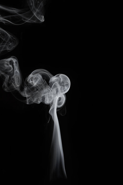 wax candle with burning wick and smoke, isolated on a black background - Foto, Imagem