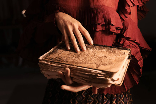 Beautiful woman with old book at home, closeup - Foto, Bild