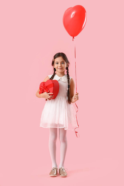 Funny little girl with gift and balloon on color background. Valentine's Day celebration - Фото, зображення