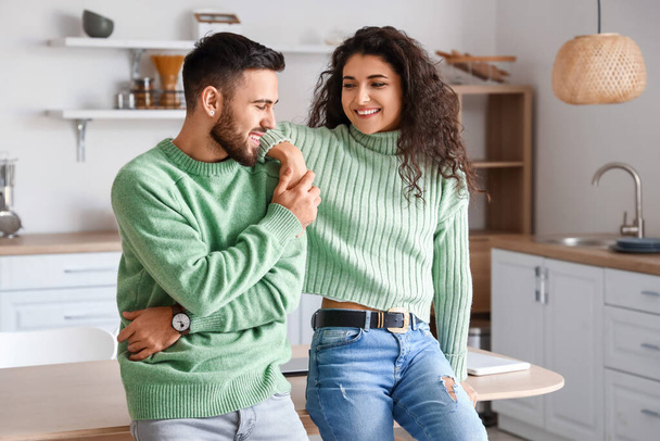 Happy young couple wearing warm sweaters at home - Foto, Imagem