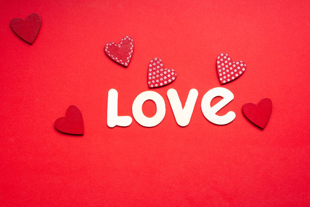 the word love on red background with small red hearts for valentines day - Photo, Image
