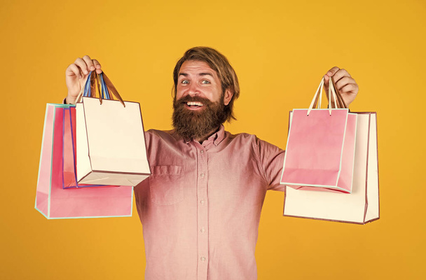 the perfect day. mature brutal hipster with present. buy in mall. happy bearded man holding gift package. happy birthday or anniversary. holiday celebration. surprise for him. shopping and sale - Fotoğraf, Görsel