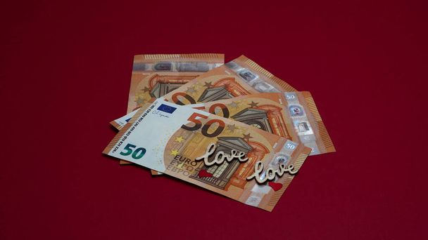 euro money on a red background with the inscription love - Foto, Imagem
